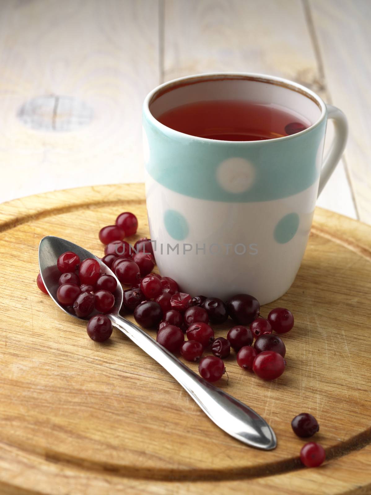 cranberry tea and berry on the wooden table