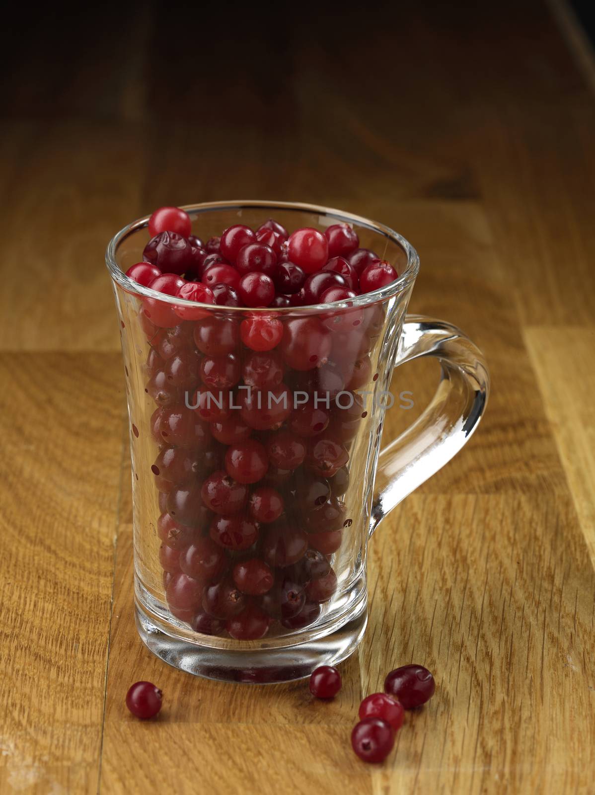 Cranberry glassy cup on the wooden table
