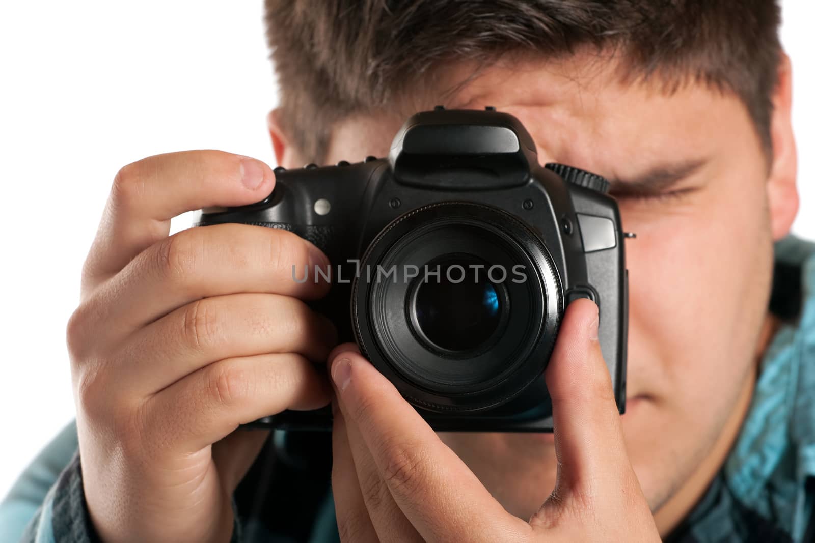 Male Photographer Shooting digital slr camera isolated on white.  Shallow depth of field.