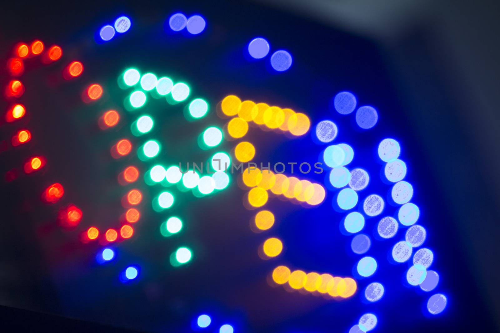 Neon open sign at night in street photo.