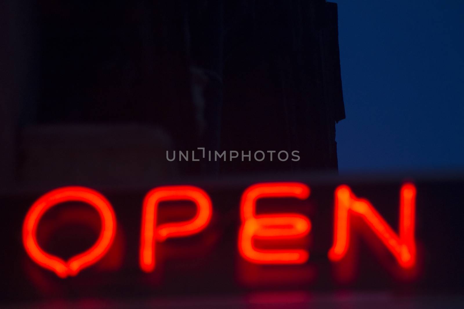 Neon open sign at night in street photo.