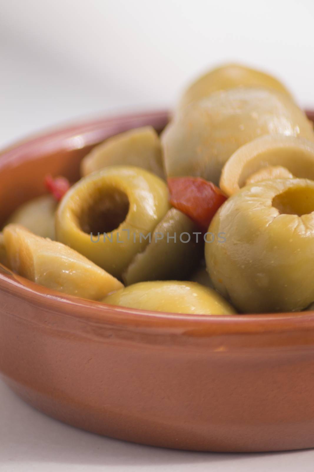 Green olives Spanish tapas bowl on table in Spain.