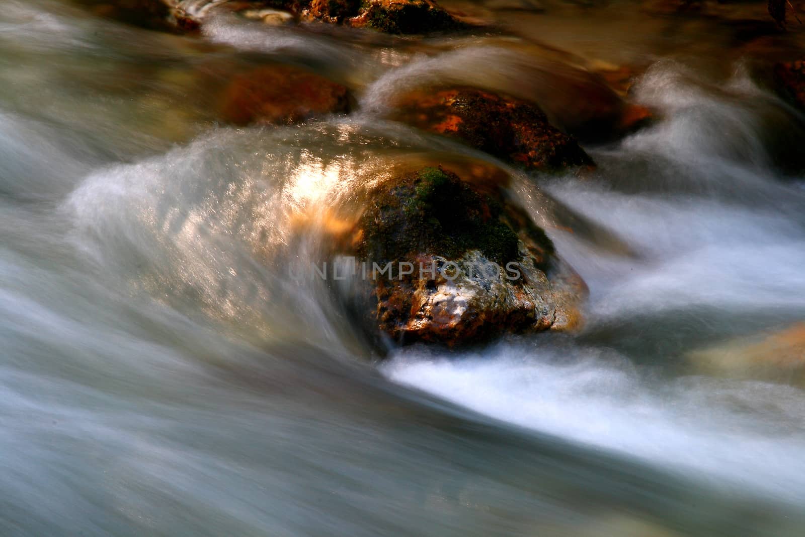 Water stream in high mountains. Longer shutter speed for blurred water. 