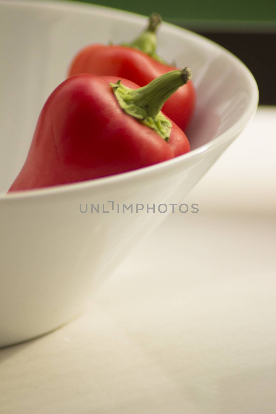 Fresh raw peppers in dish by edwardolive