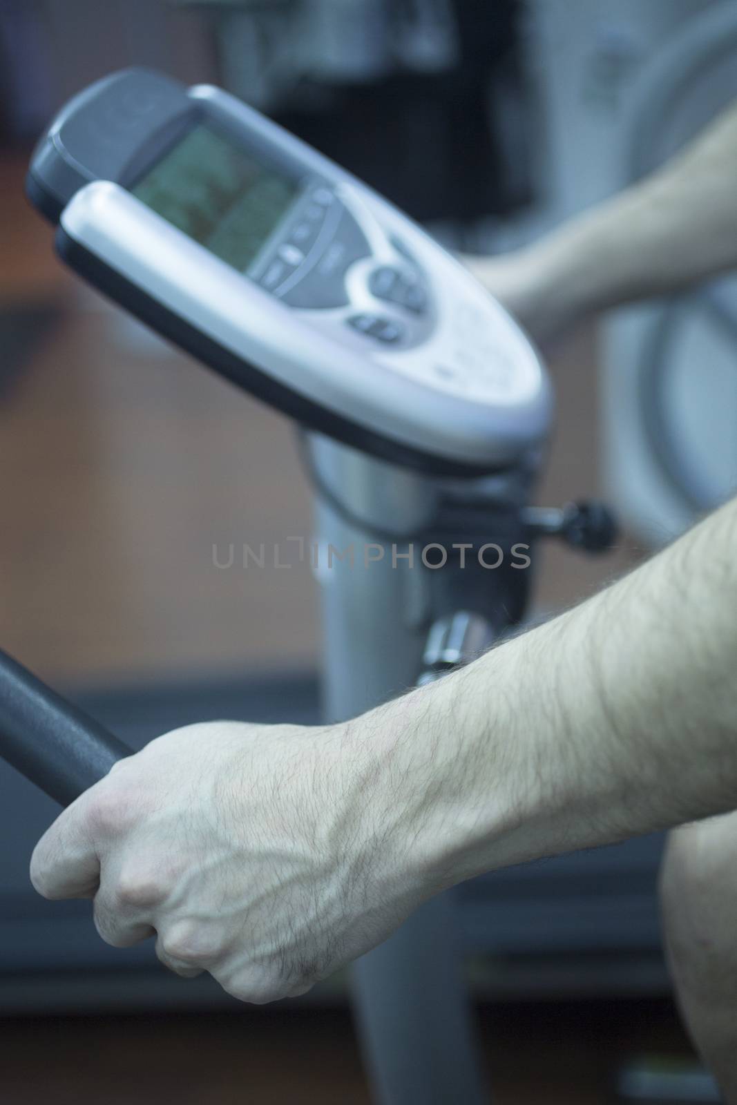 Young man on exercise bicycle in physiotherapy gym fitness center clinic.