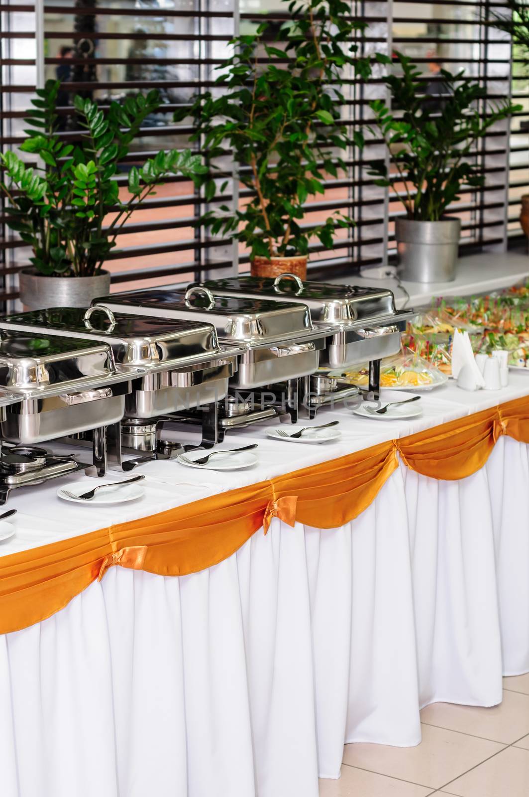 chafing dishes at table ready for wedding catering