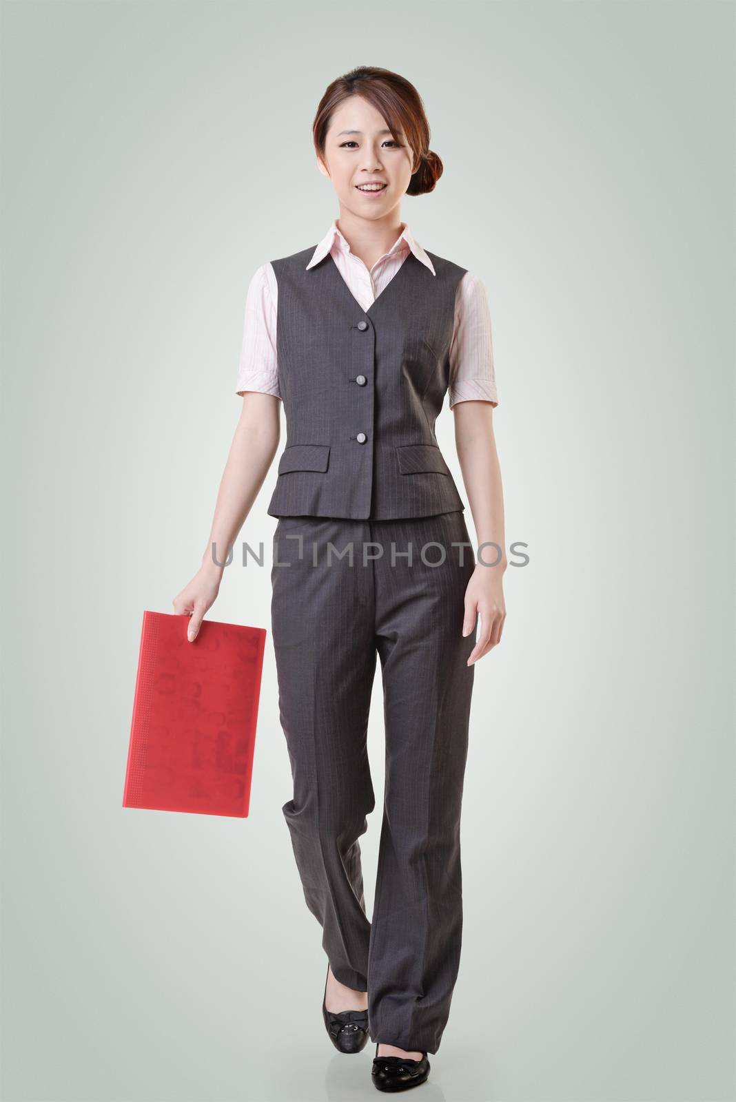 Asian business woman standing against studio background, full length portrait with clipping path.