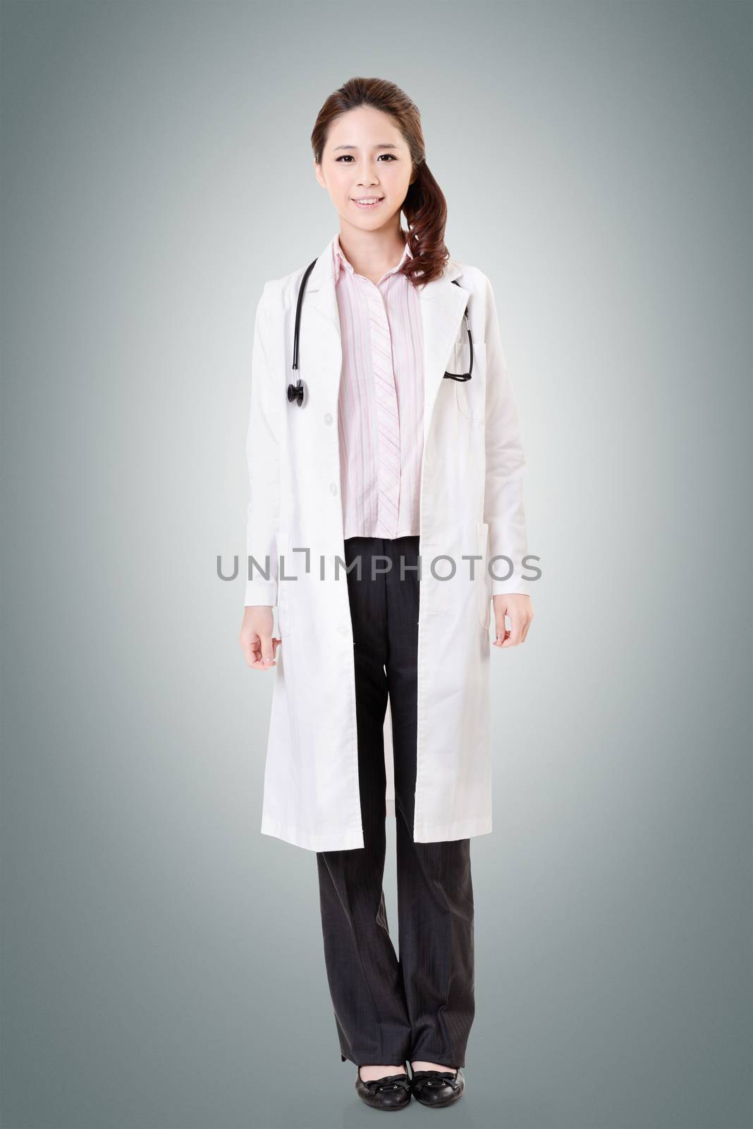 Friendly Asian doctor woman, full length portrait isolated on white background.