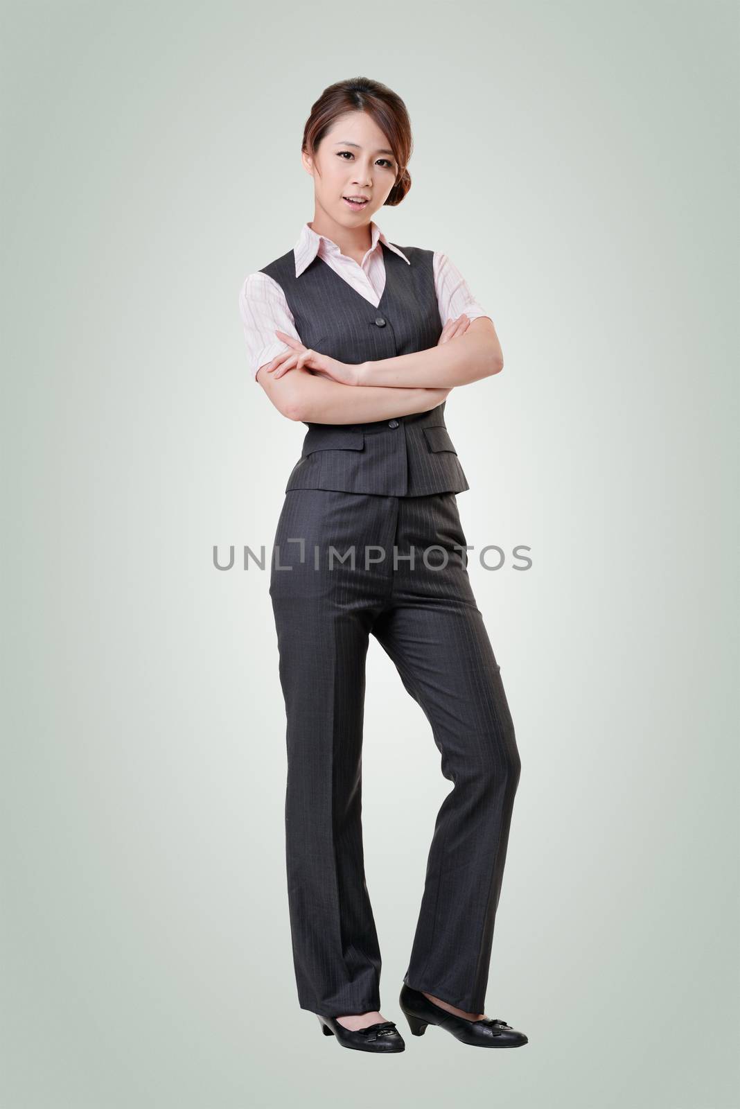 Asian business woman standing against studio background, full length portrait with clipping path.