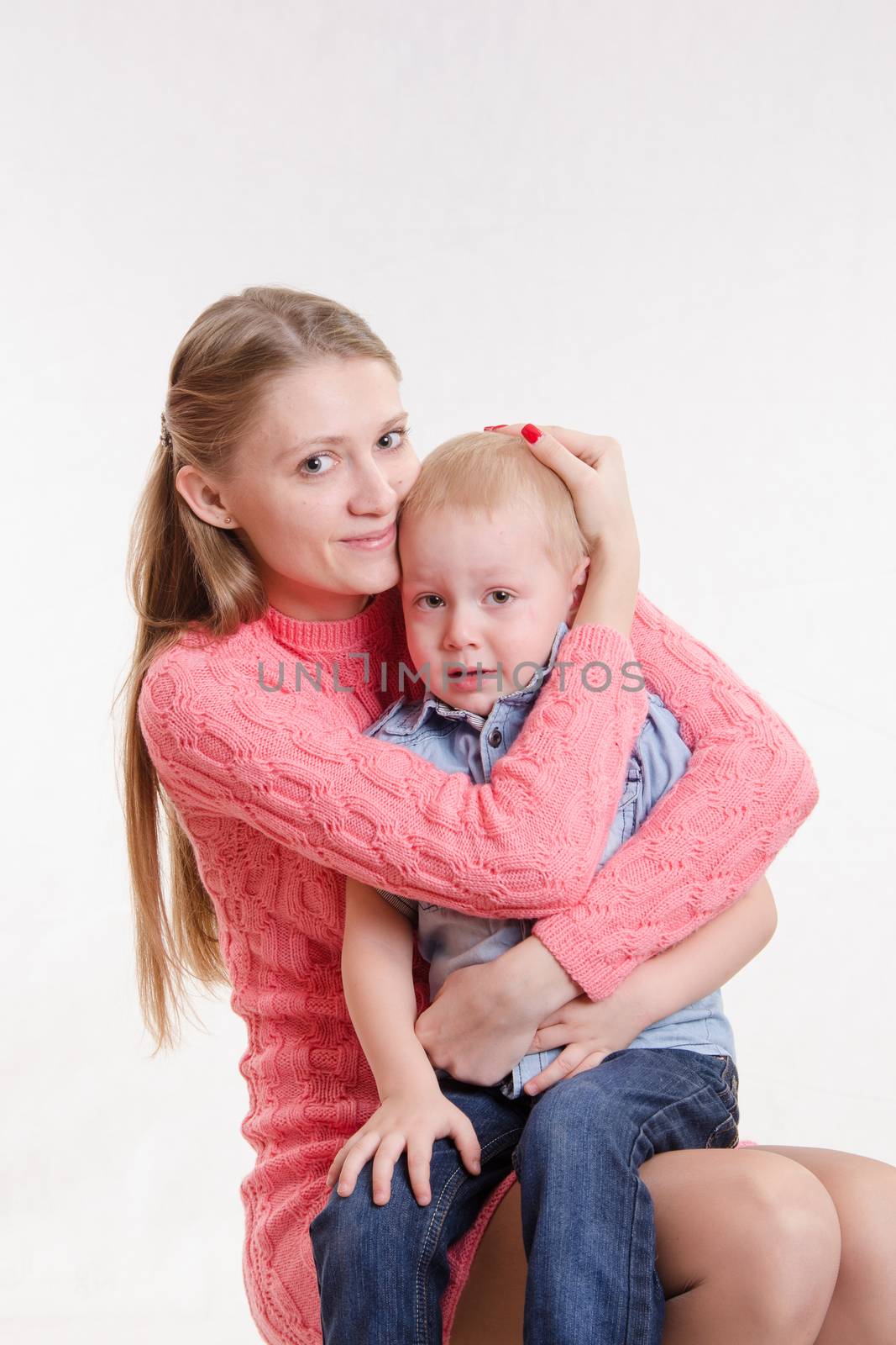 On the lap of a young beautiful girl sits her three year old son