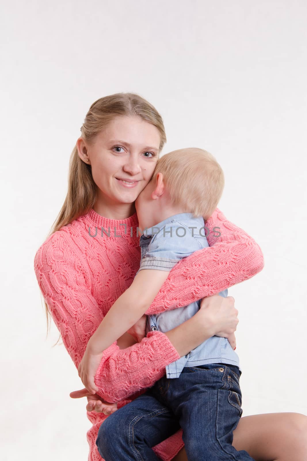 On the lap of a young beautiful girl sits her three year old son