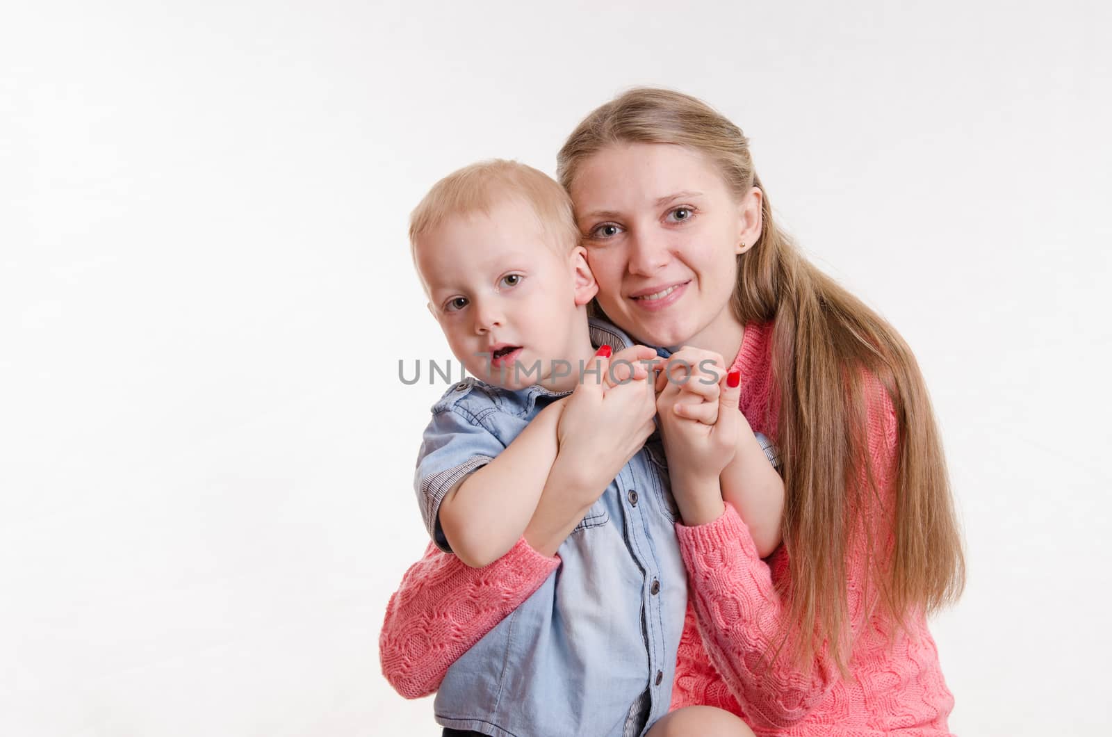 Young beautiful girl sitting on a chair with a three year old son
