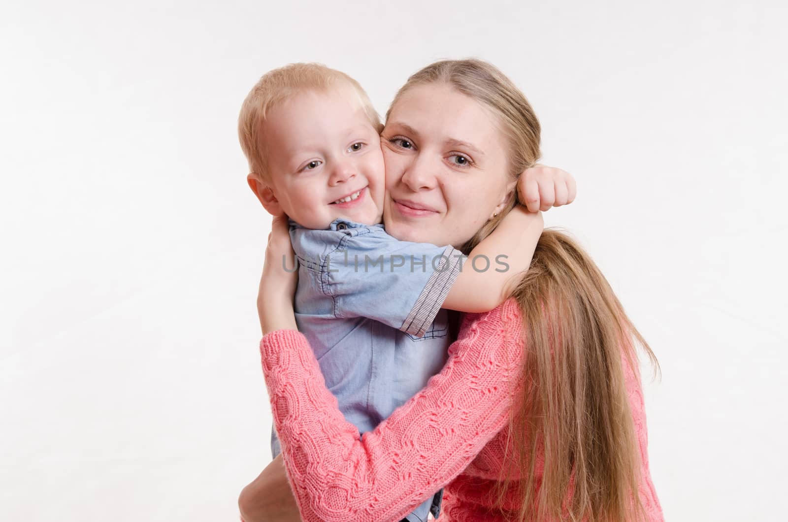 On the lap of a young beautiful girl sits her three year old son