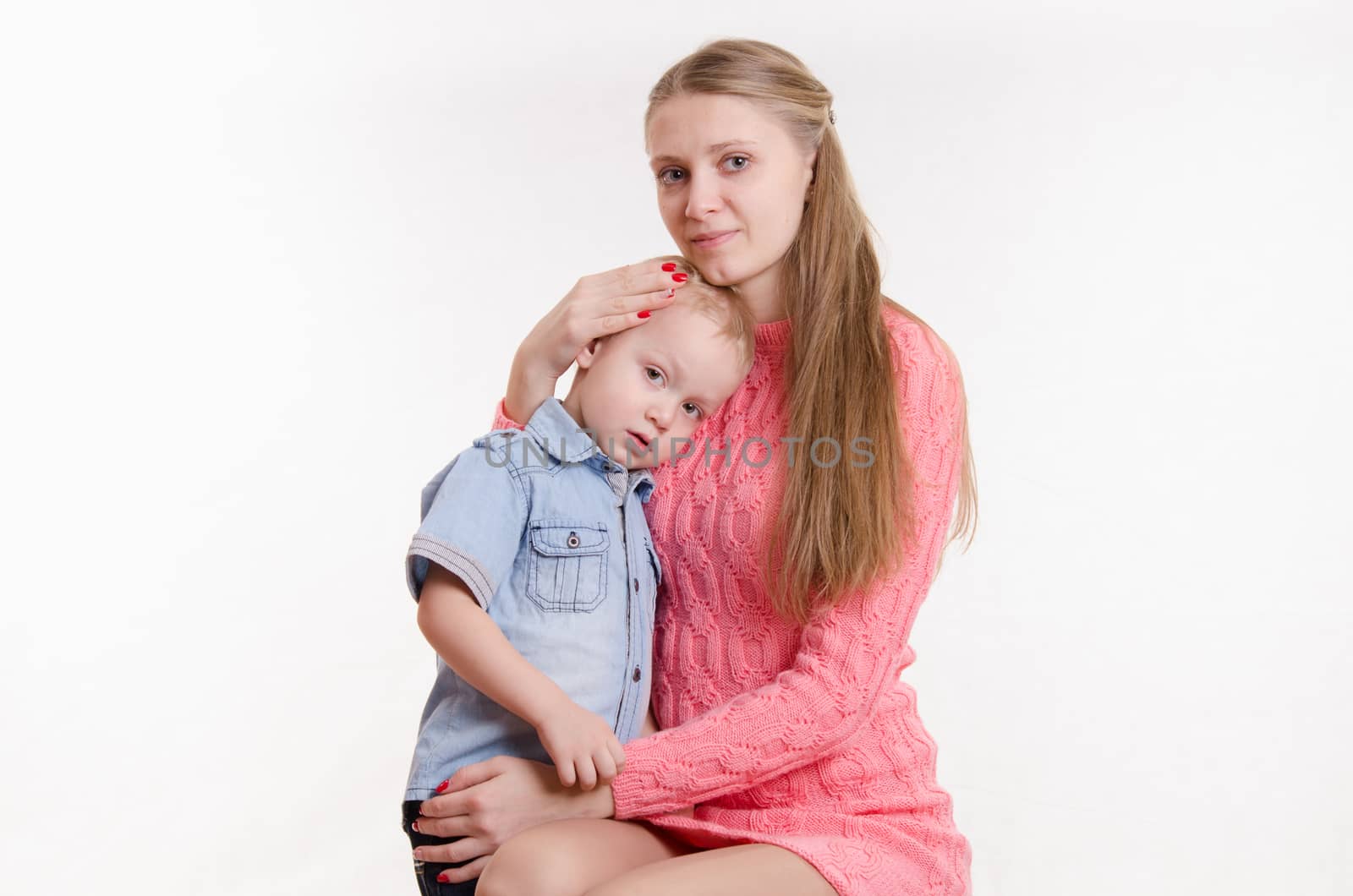 Young beautiful girl sitting on a chair with a three year old son
