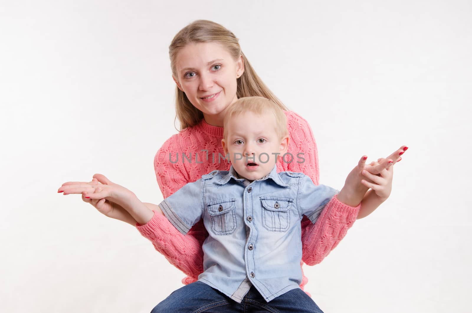 Young beautiful girl sitting on a chair with a three year old son