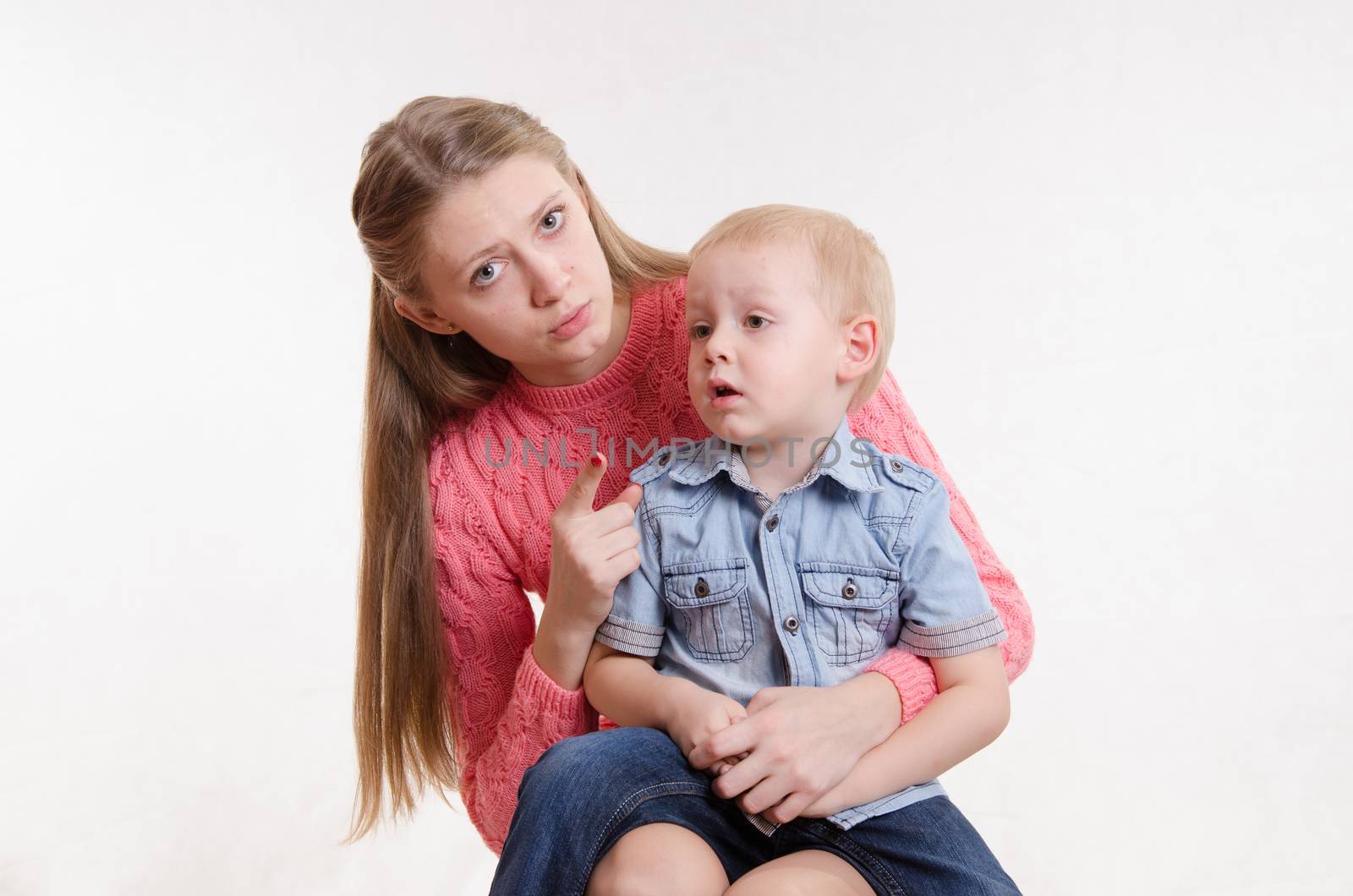 Young beautiful mother scolds her rebellious and moody three year old boy