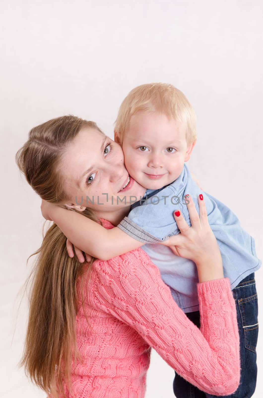 Young beautiful girl hugging his three sons