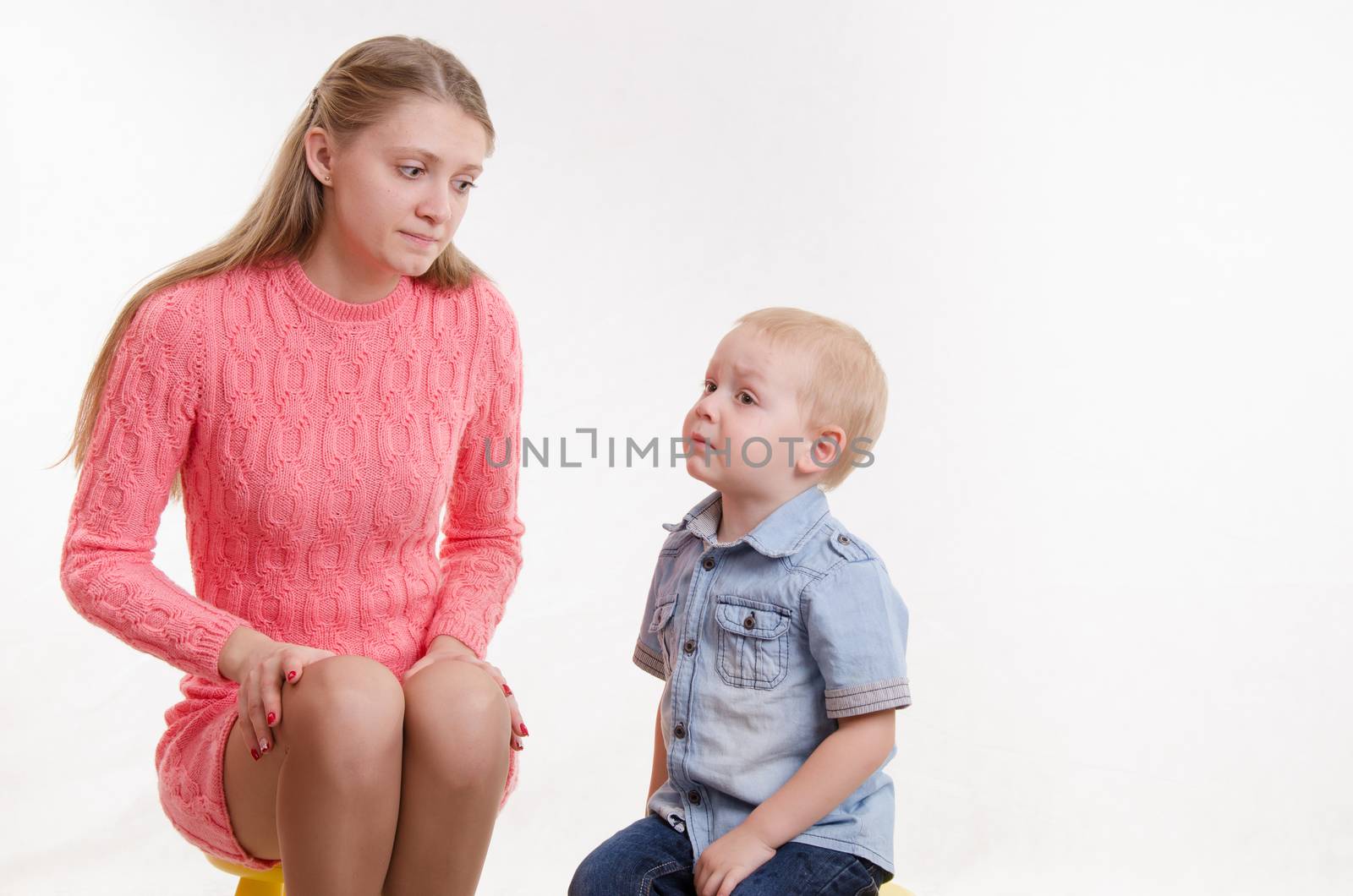 Young beautiful mother scolds her rebellious and moody three year old boy