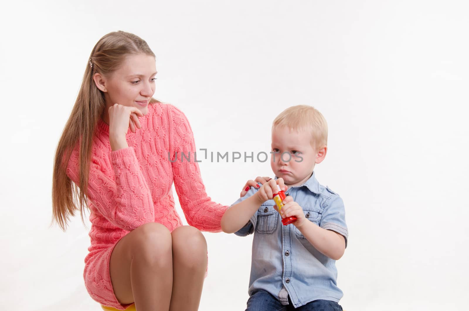 Young beautiful girl blow bubbles with a three year old son