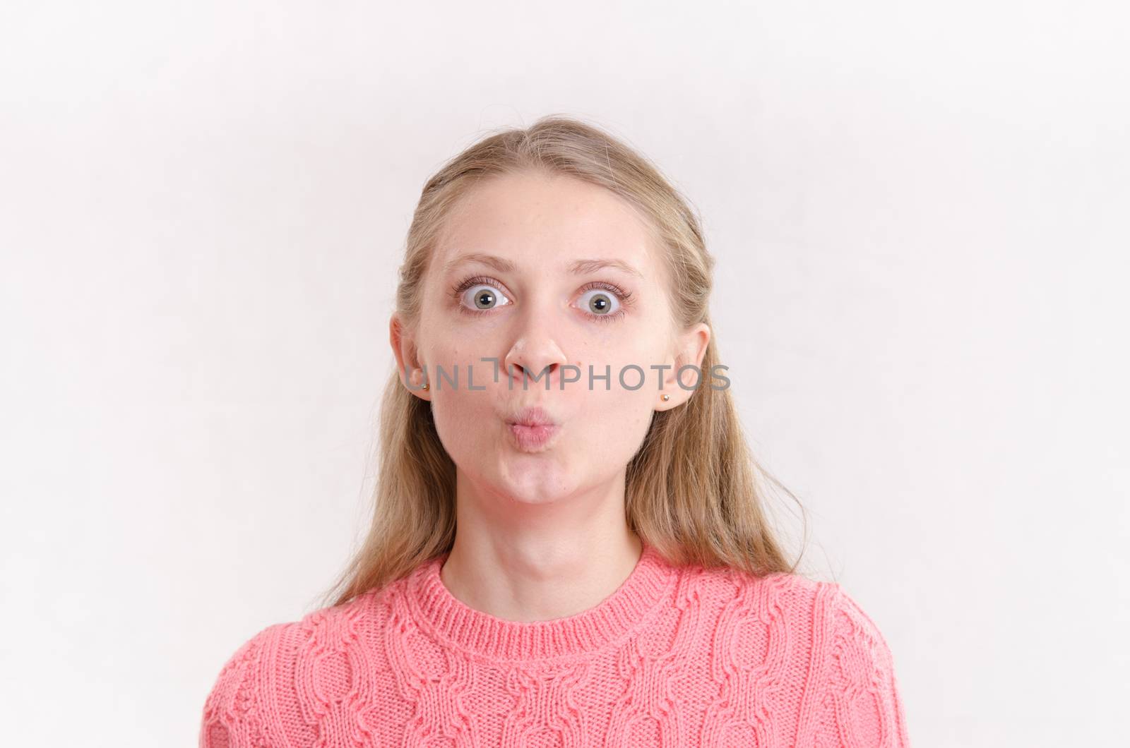 Portrait of a young emotional beautiful girl of the European appearance on a white background