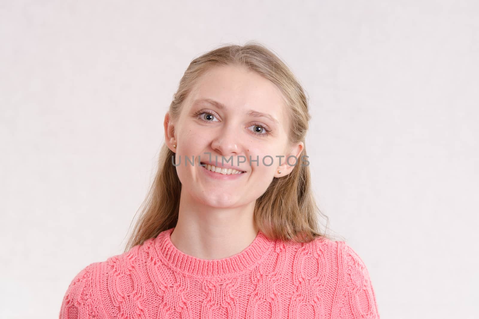 Portrait of a young emotional beautiful girl of the European appearance on a white background