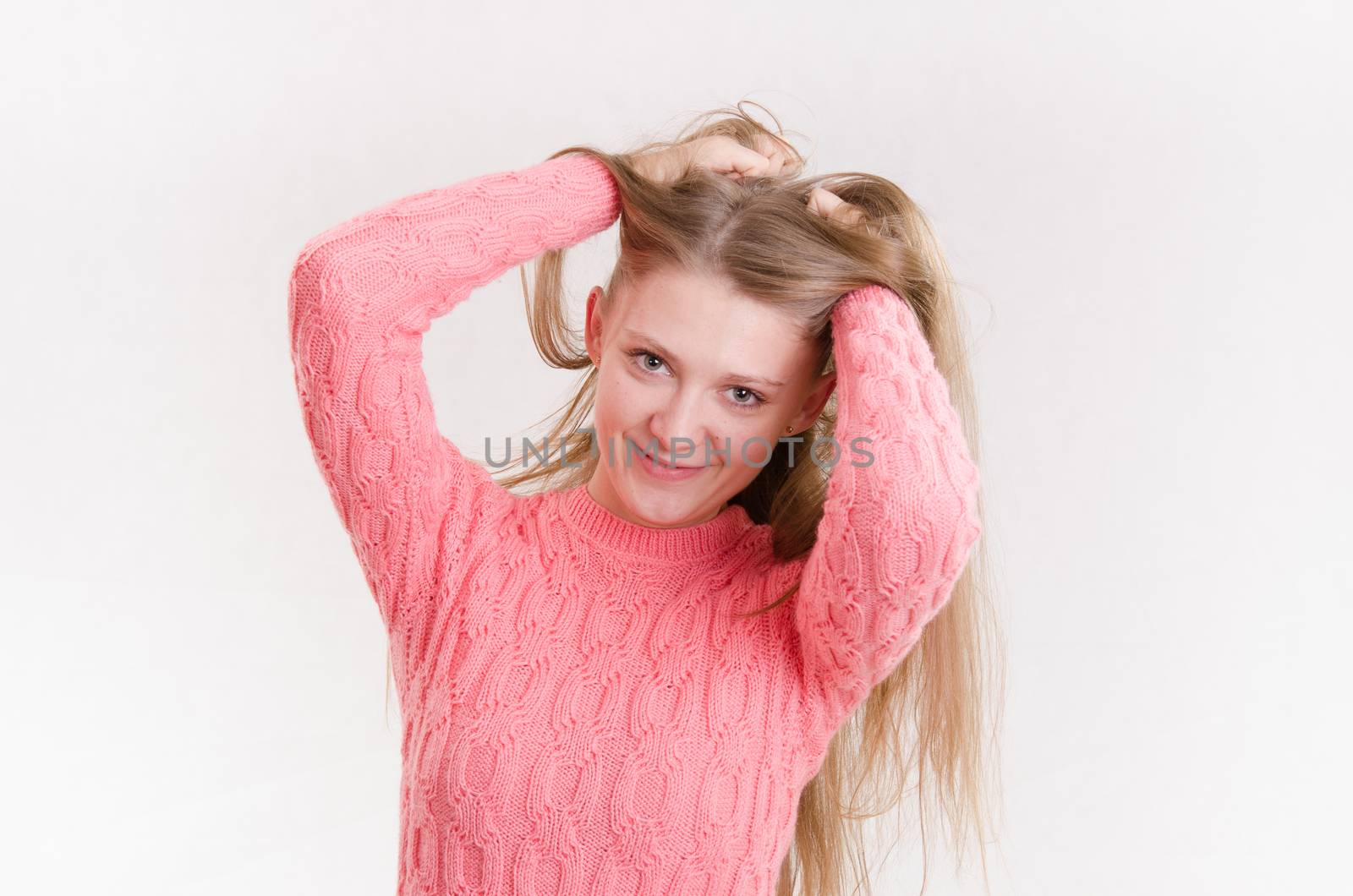 Portrait of a young emotional beautiful girl of the European appearance on a white background