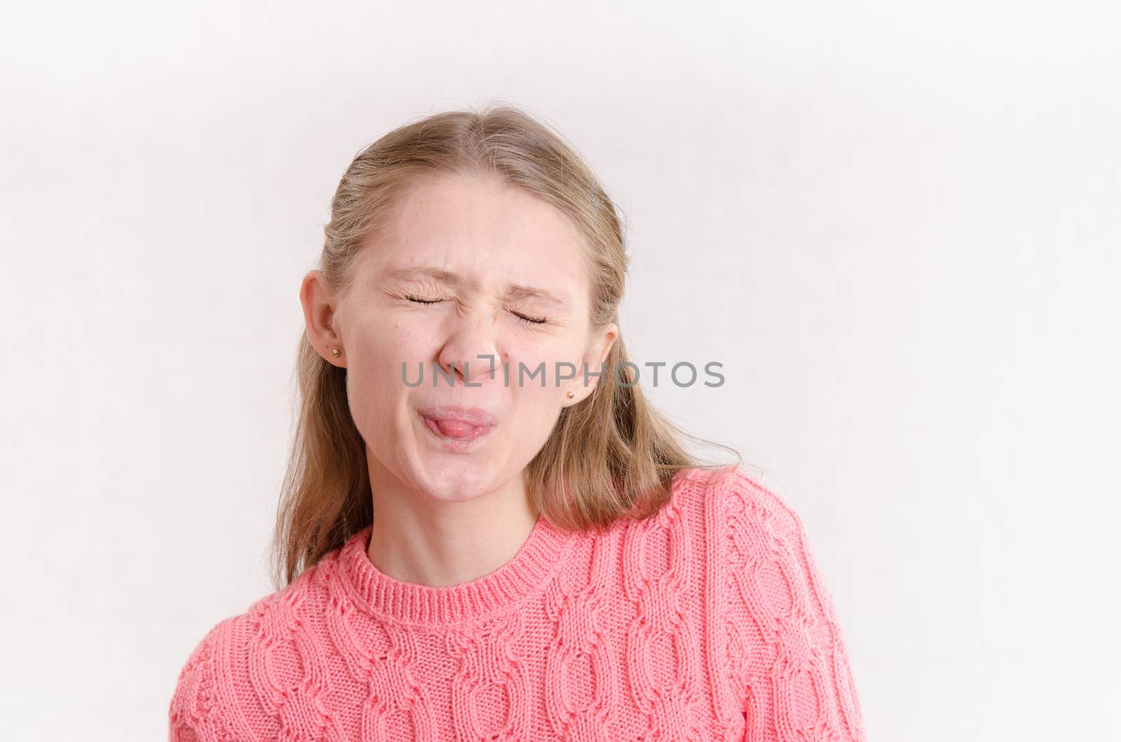 Portrait of a young emotional beautiful girl of the European appearance on a white background