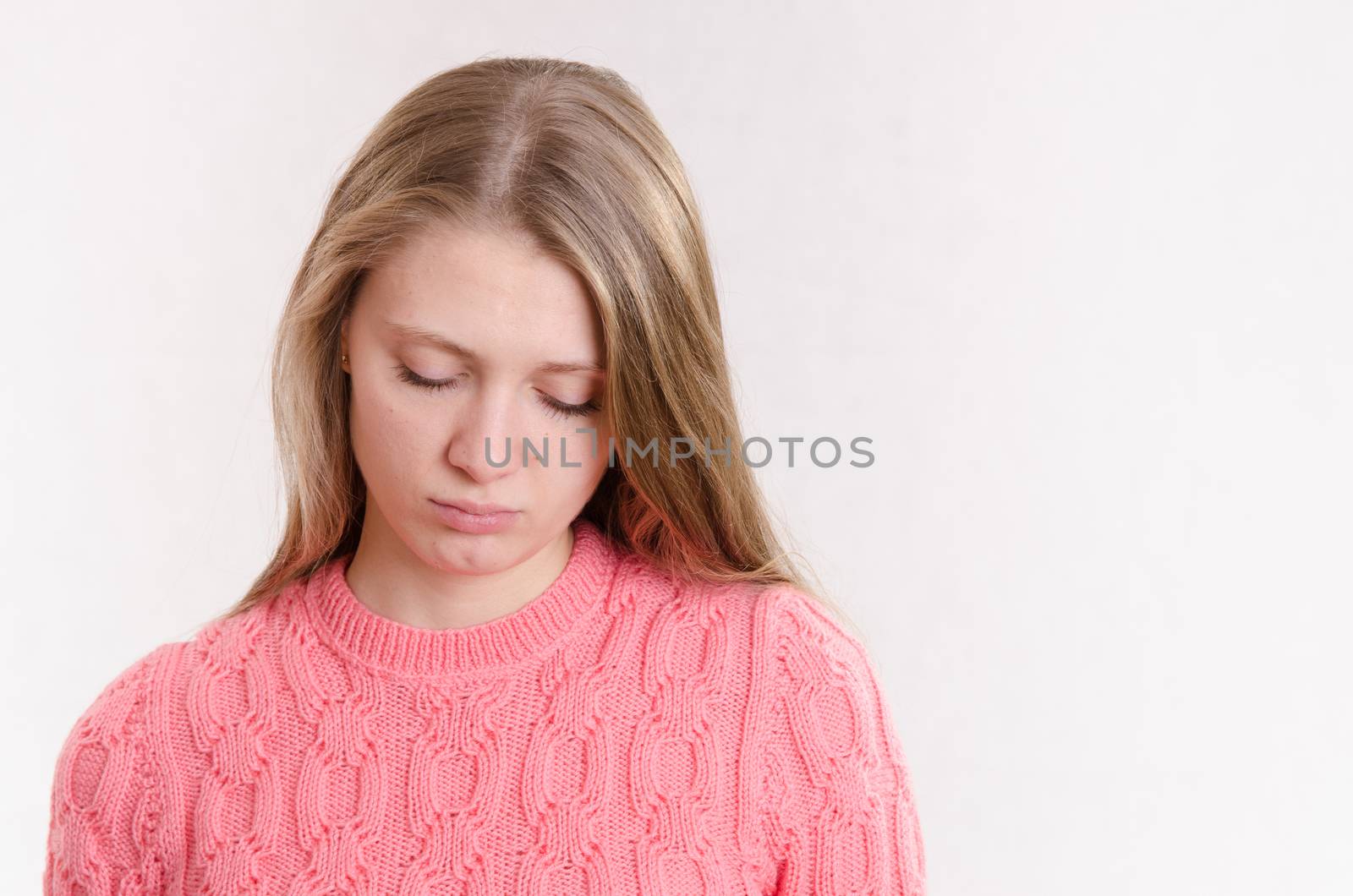 Portrait of a young emotional beautiful girl of the European appearance on a white background