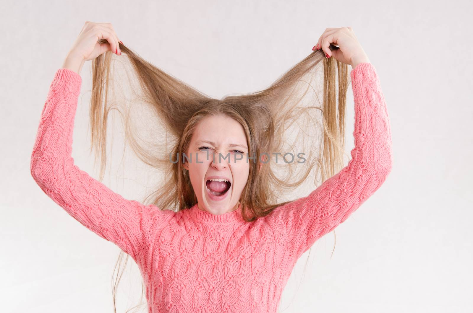 Portrait of a young emotional beautiful girl of the European appearance on a white background