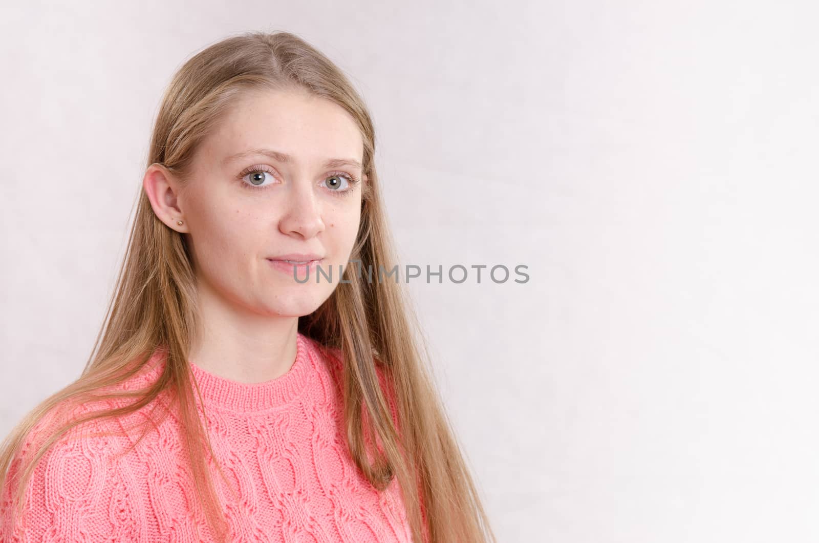 Portrait of a young beautiful girl of the European appearance on a white background