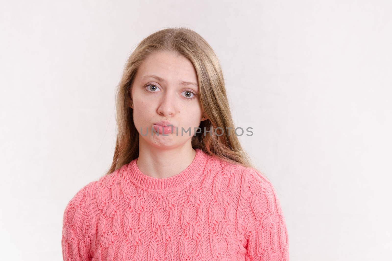 Portrait of a young emotional beautiful girl of the European appearance on a white background