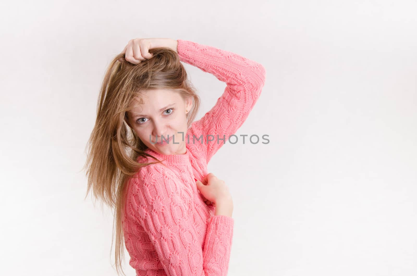 Portrait of a young emotional beautiful girl of the European appearance on a white background