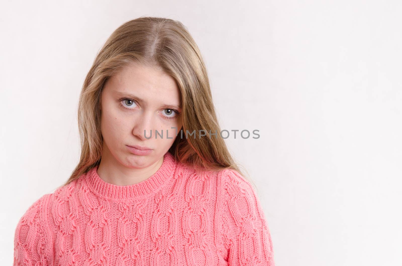 Portrait of a young emotional beautiful girl of the European appearance on a white background