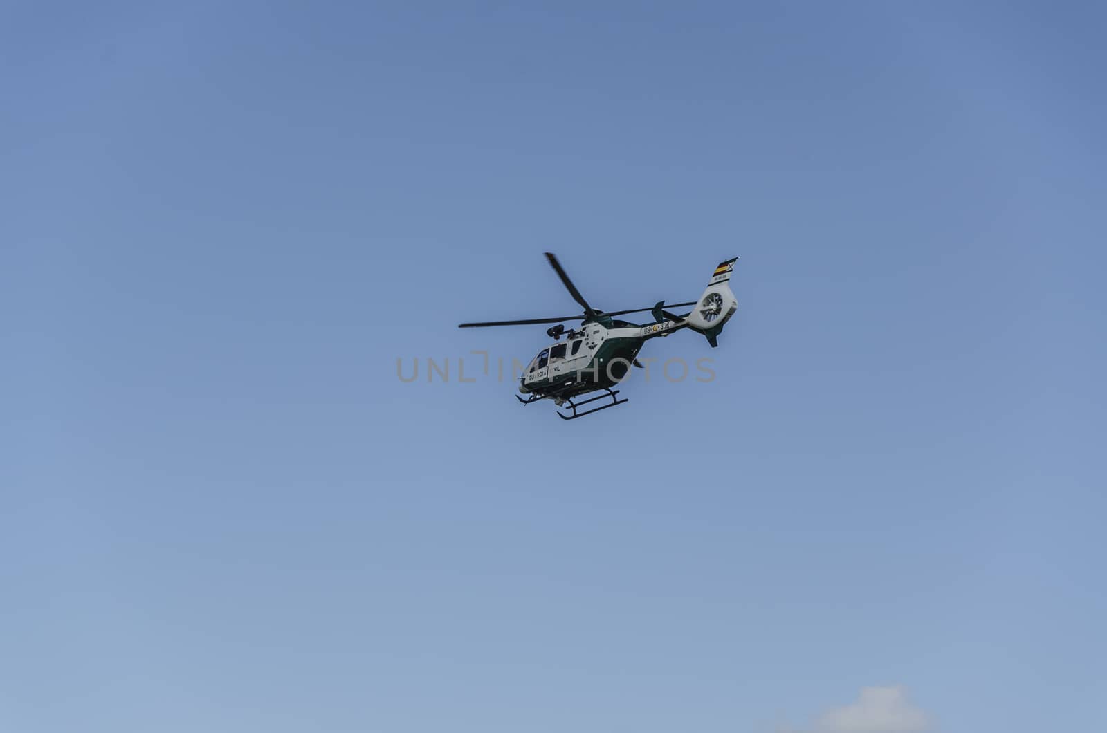 Chopper of Guardia civil patrulling over the mountain in Spain