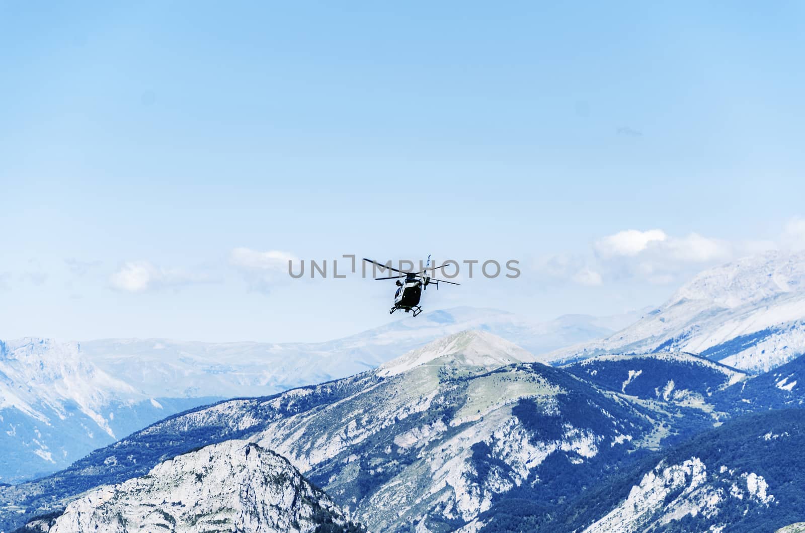 Chopper of Guardia civil patrulling over the mountain in Spain
