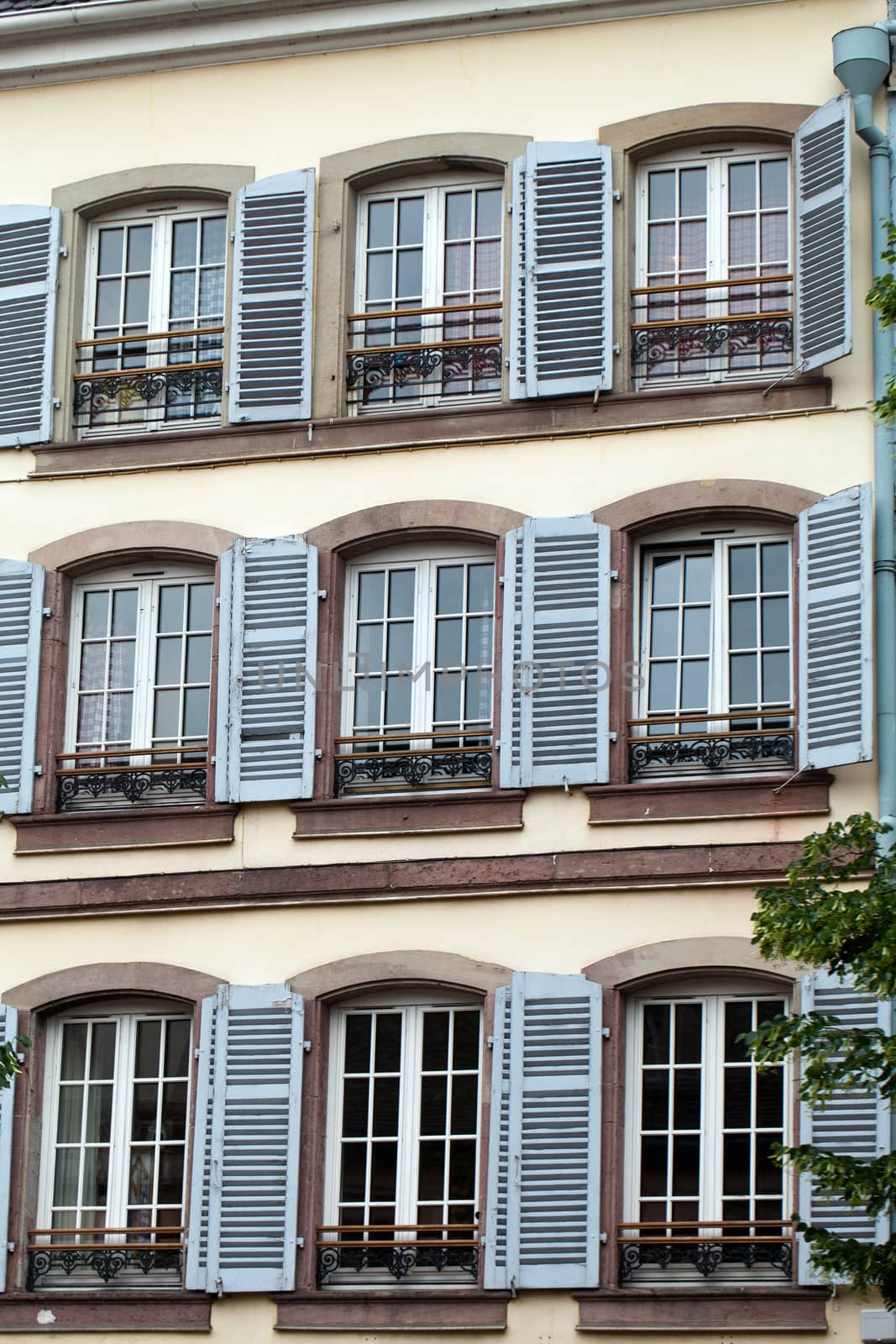 the facade with blue window shutters