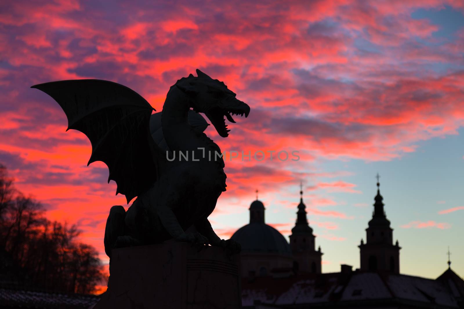 Vivid sunset sky over silhouette of Famous Dragon bridge, symbol of Ljubljana, capital of Slovenia, Europe.