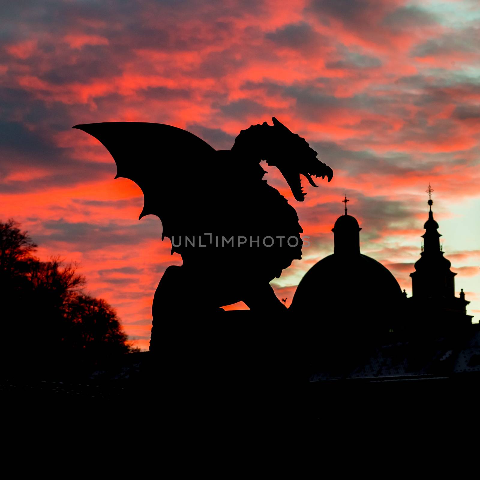 Vivid sunset sky over silhouette of Famous Dragon bridge, symbol of Ljubljana, capital of Slovenia, Europe.