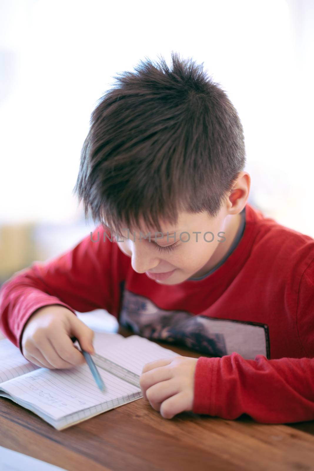 Boy doing homework mathematics at home