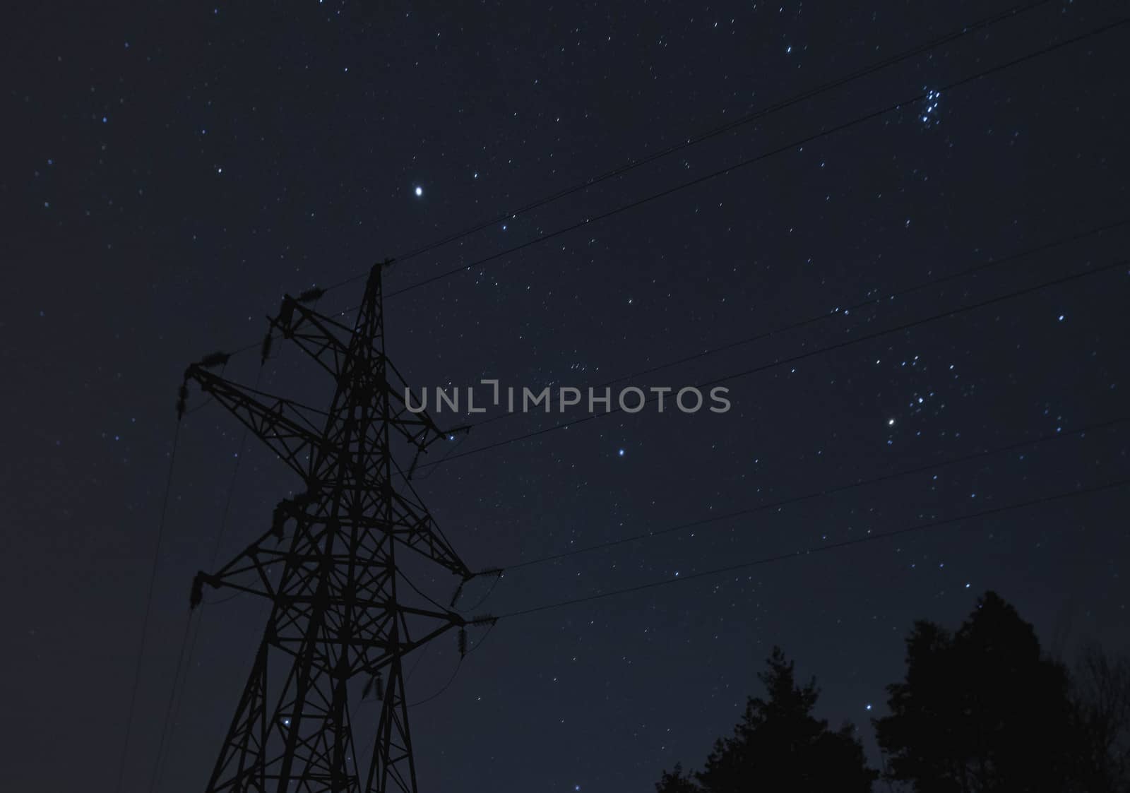 Transmission tower on a background of the starry sky.