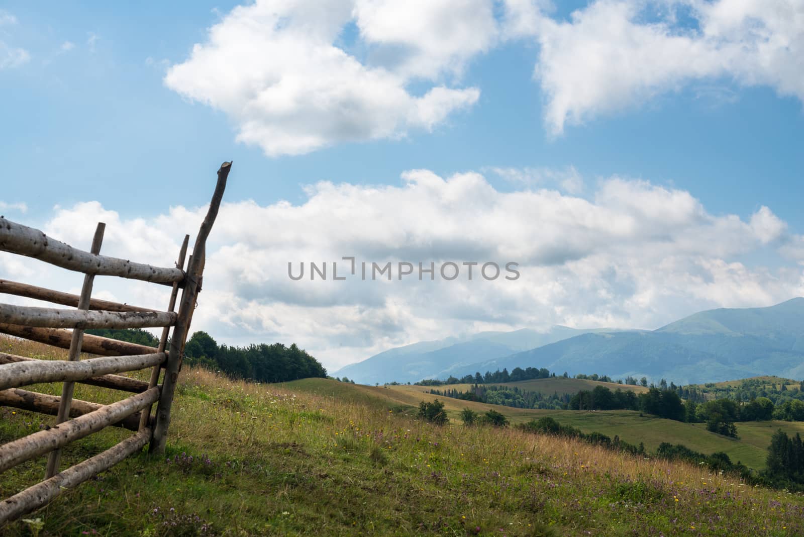 Wooden fence against the landscape in the Ukrainian Carpathians by rootstocks