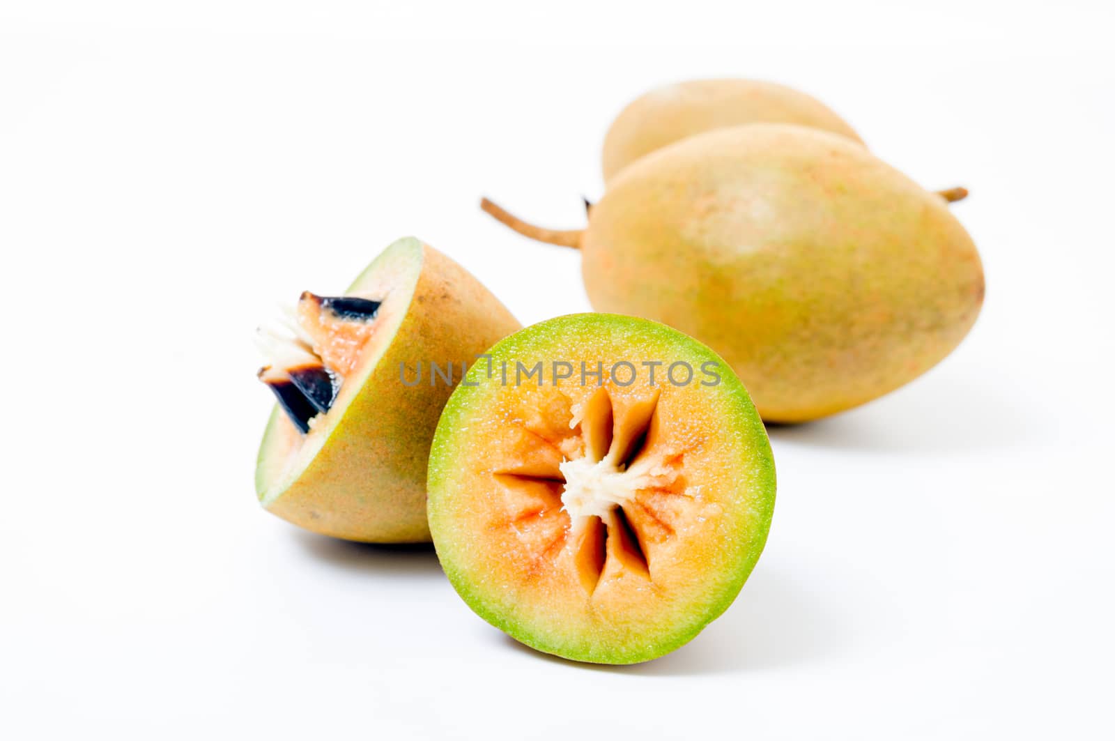 Fresh sapodillas isolated on white background  by pixbox77