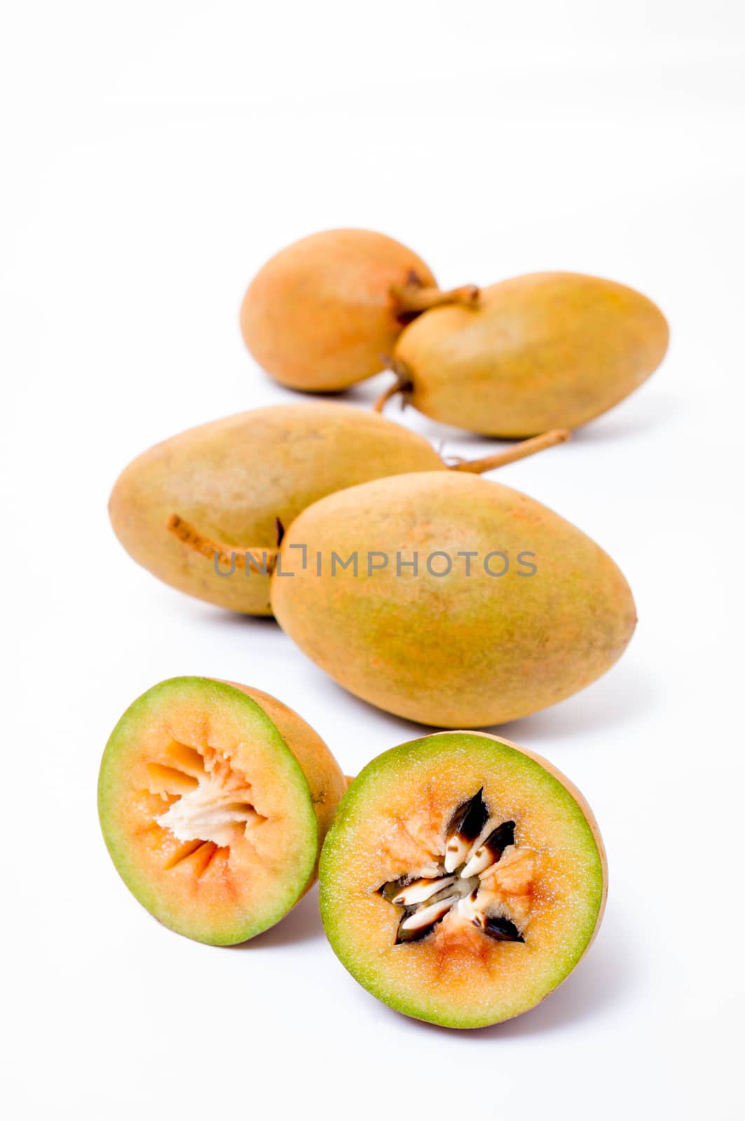 Fresh sapodillas isolated on white background  by pixbox77