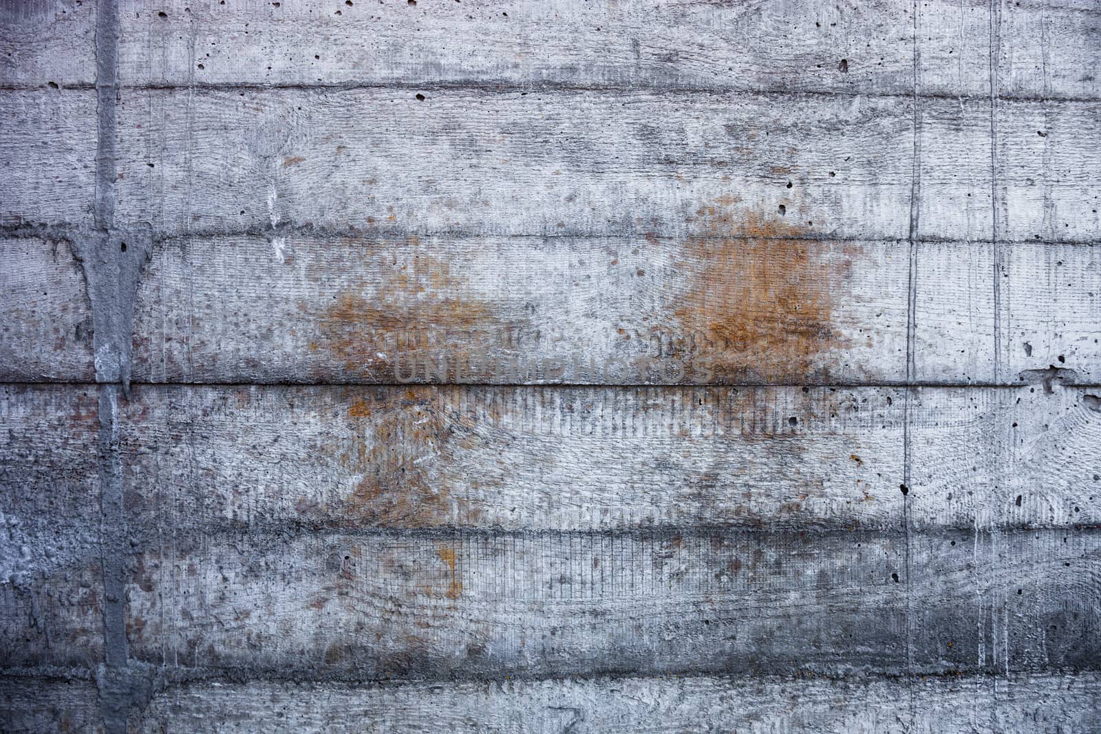 Grey concrete wall with hardened traces of the shuttering moulds