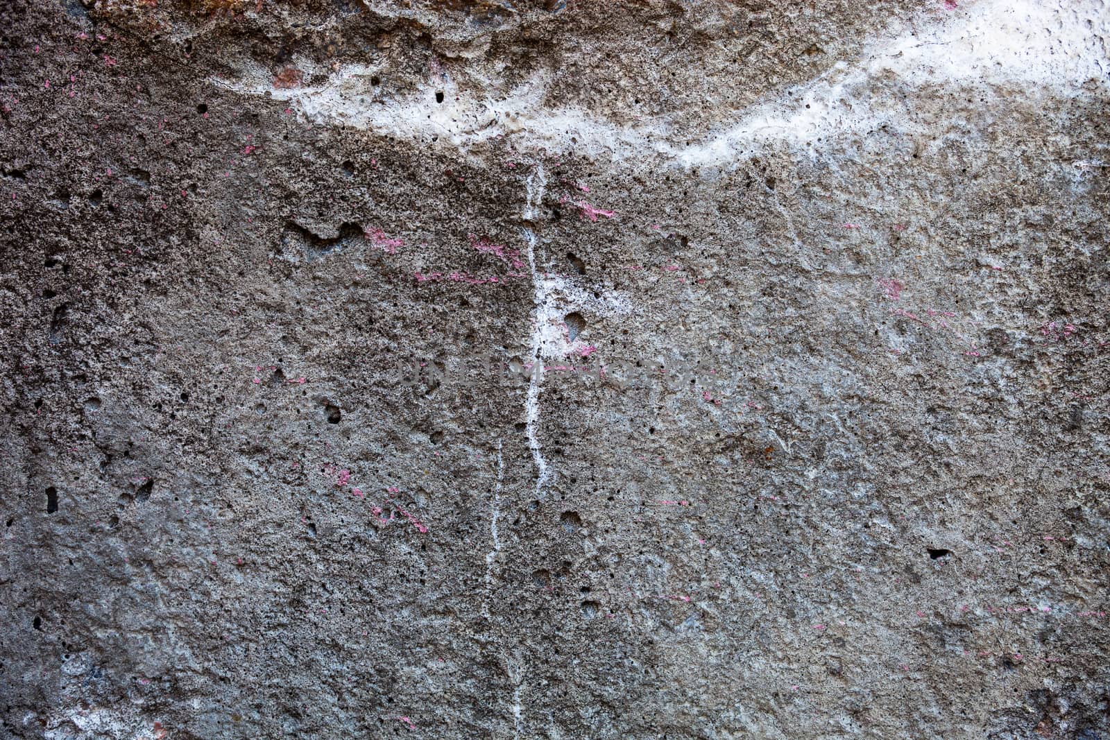 Concrete surface with spots of rust, lime and paint