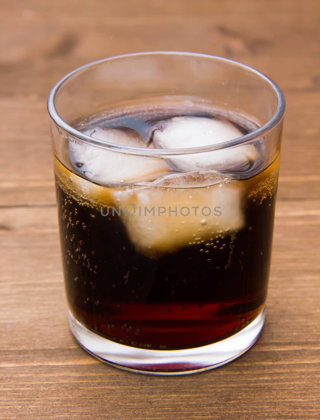 Glass of cola on wood by spafra