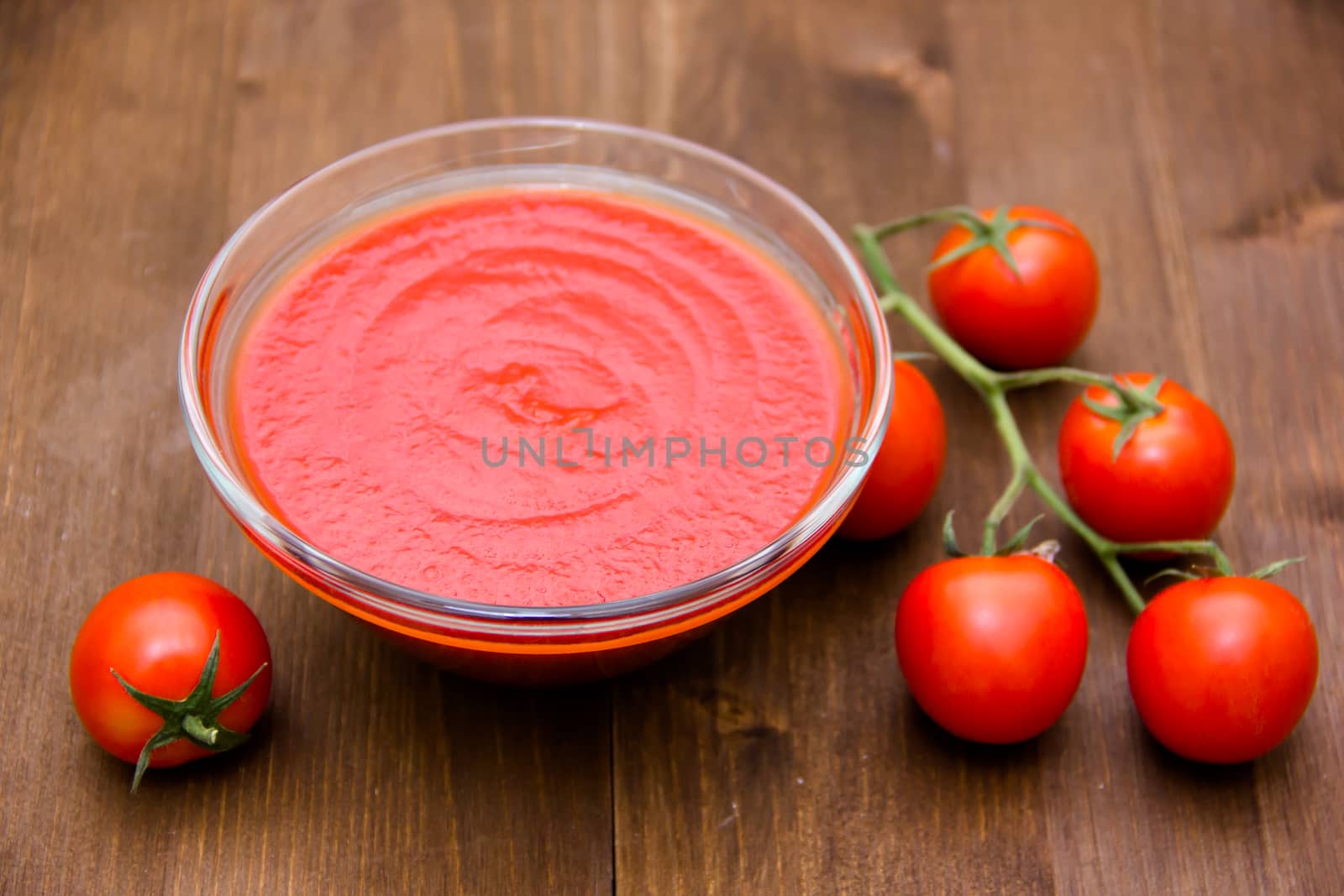 Tomato sauce on bowl on wooden table