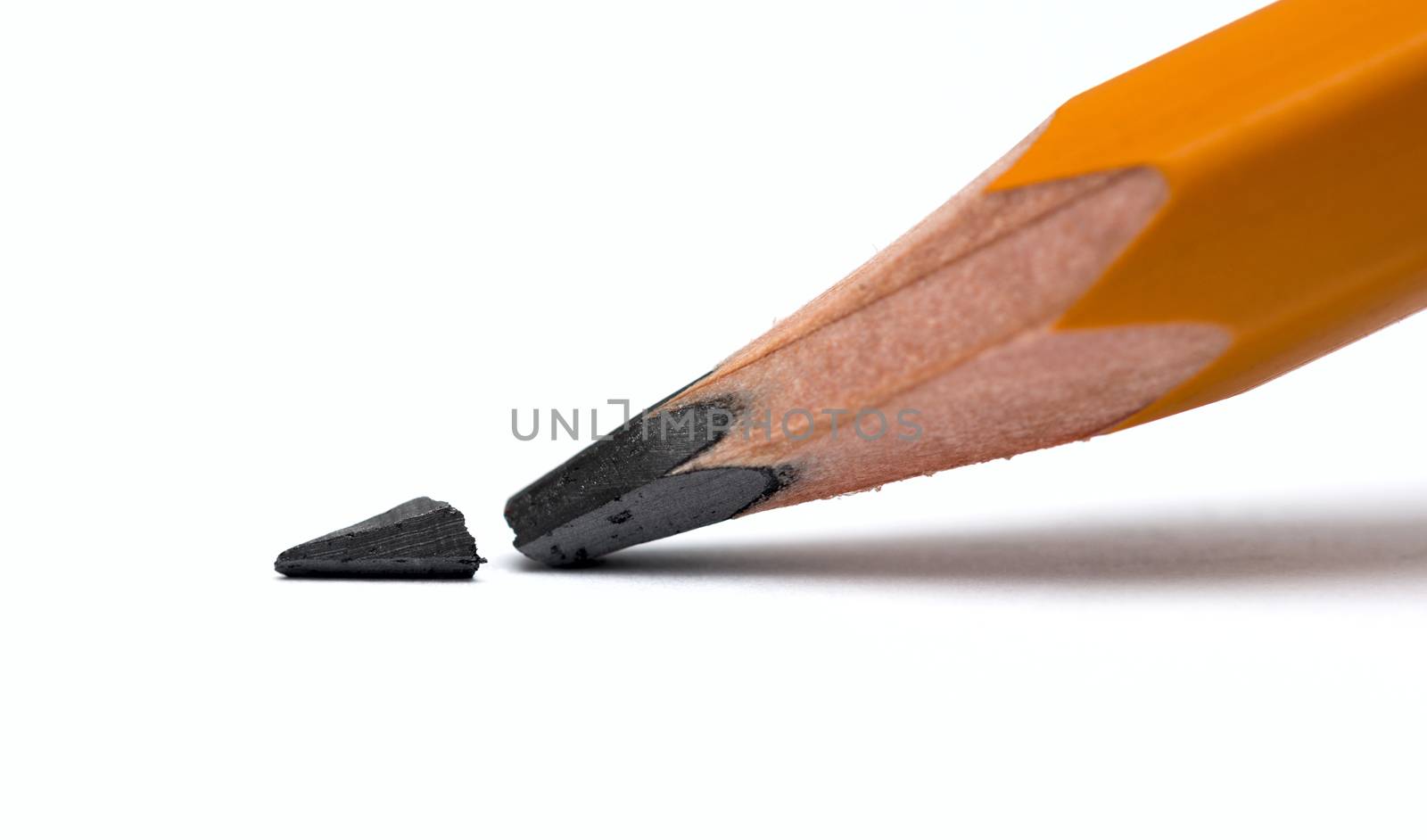 Broken head of sharp pencil on a white paper by DNKSTUDIO