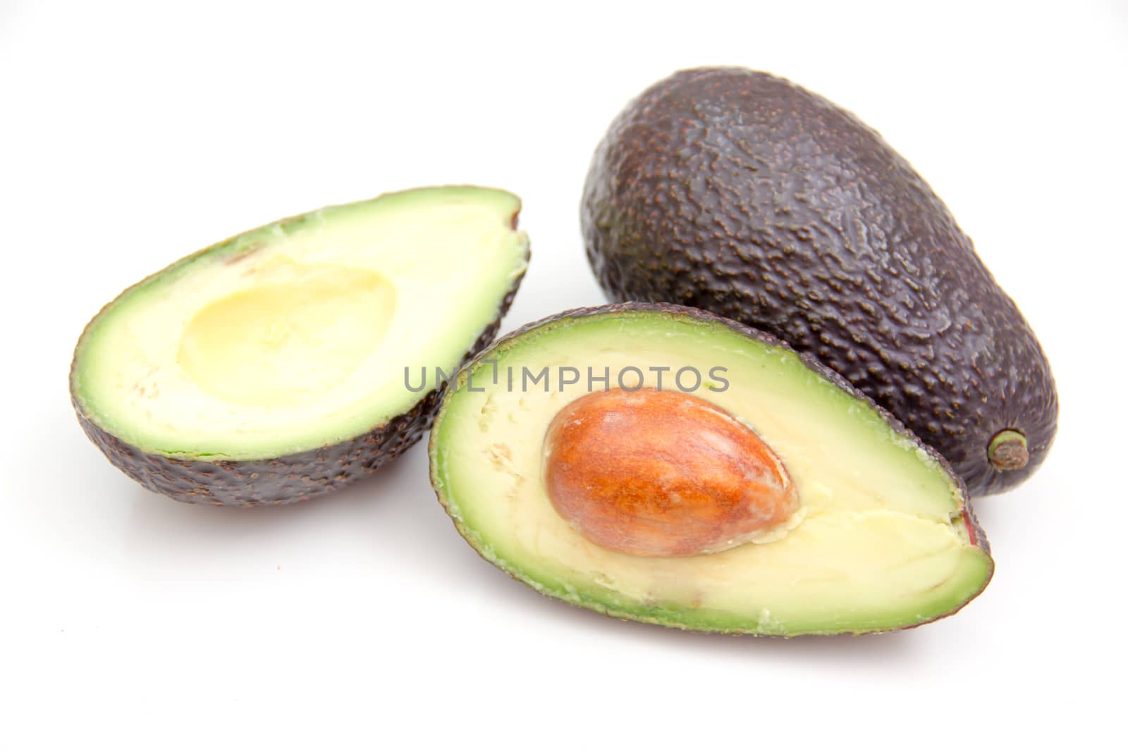 Some avocado seen up close on a white background