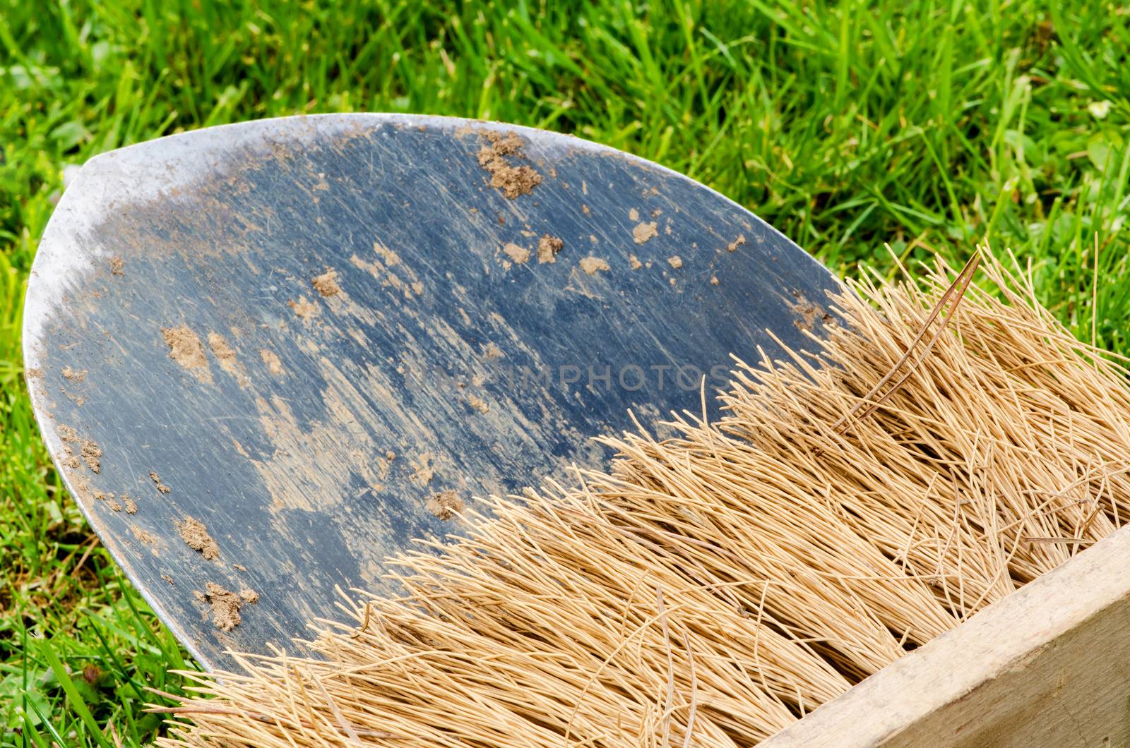 Used bristle on the black shovel, rusty texture.